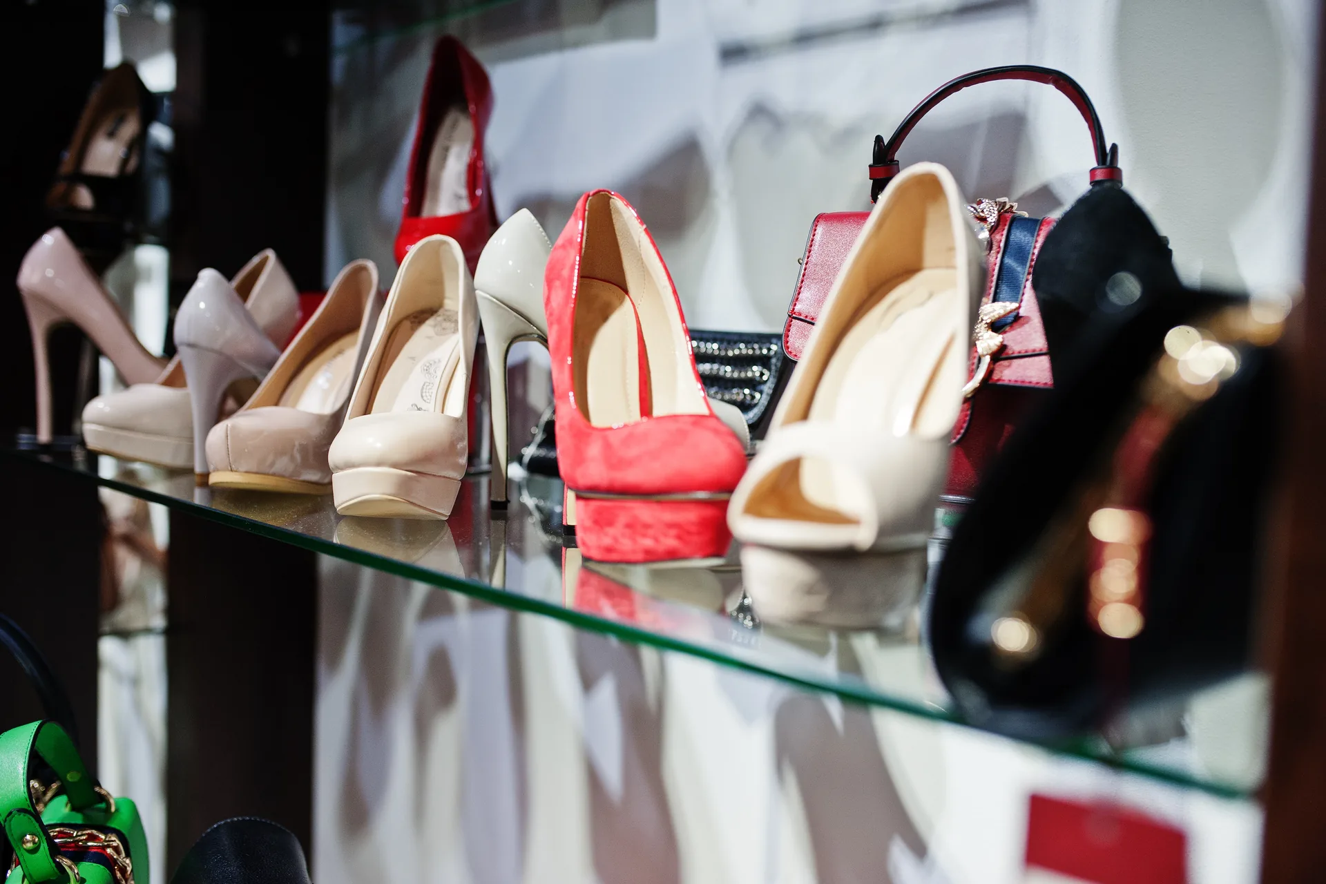 DIVA Shoes: case study · Soluzioni Digitali Personalizzate | FV Digital Agency Scarpe e borse da donna di colori diversi esposte su uno scaffale in vetro: progetto DIVA Shoes di FV Digital Agency