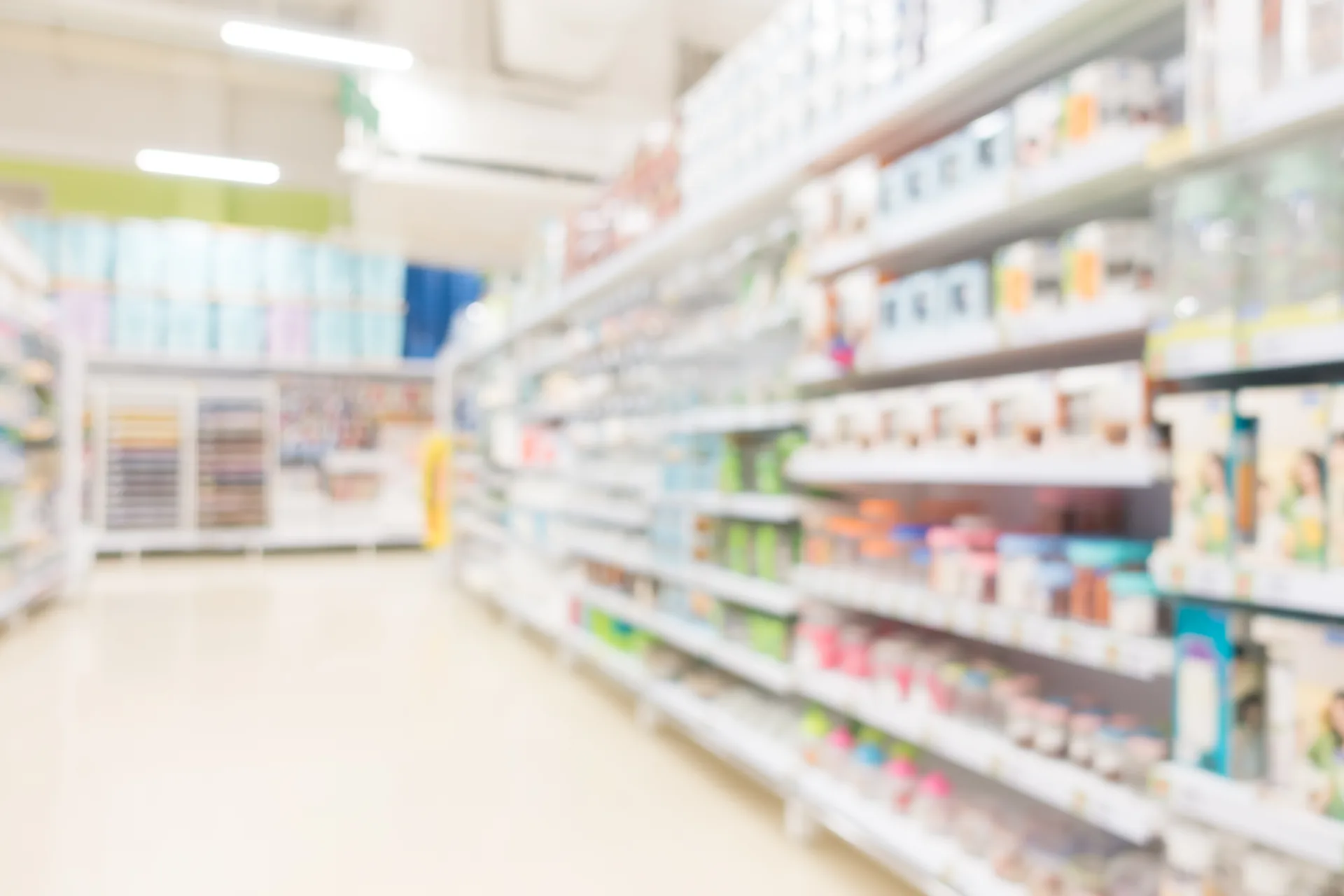 Corsia di farmacia con scaffali di prodotti, sfocata: progetto Farmacia Maddaloni di FV Digital Agency